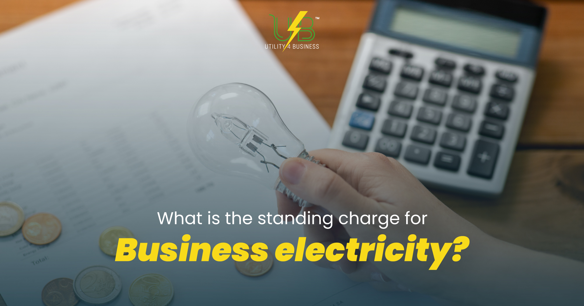 Hand holding lightbulb near coins and calculator, showing UK business electricity standing charges Utility4Business.